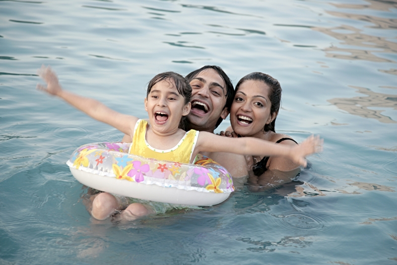 summer travel - Family playing in swimming pool
