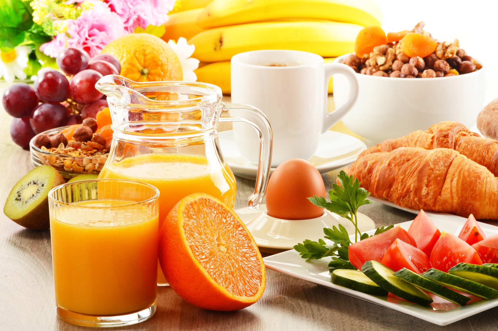 Breakfast with coffee, orange juice, croissant, egg, vegetables