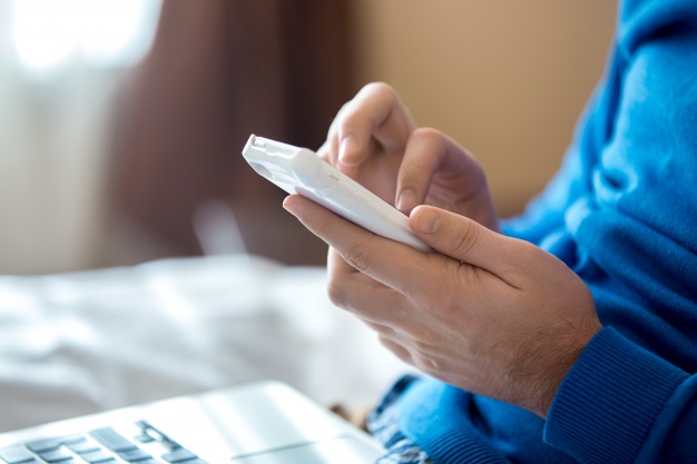 close-up-of-hands-using-a-smartphone_1218-391